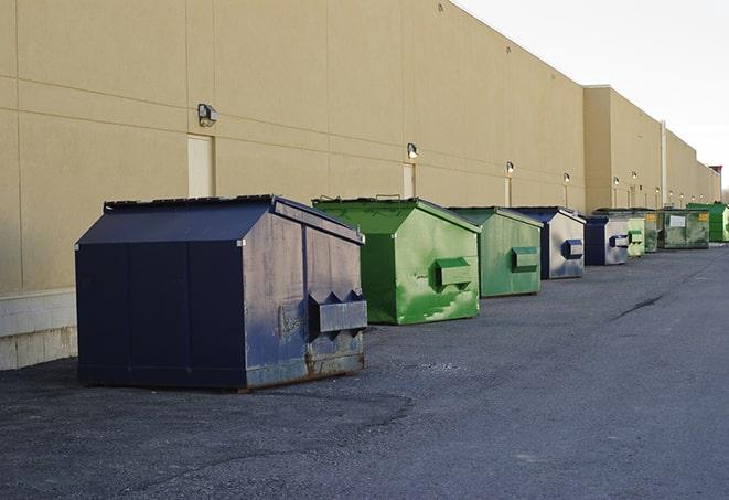 a compact construction dumpster being emptied by a waste disposal truck in Cle Elum